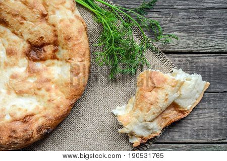 Pita flatbread,. traditional asian bread on wooden background