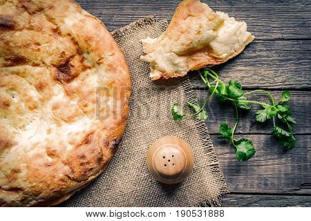 Pita flatbread,. traditional asian bread on wooden background