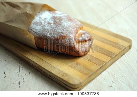 Whole pineapple pie on a cutting board at the kitchen