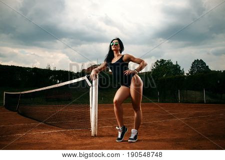 Beautiful Young Free Sports Sexy Girl Dressed In Bodysuit, Sneakers, With A Smart Ass And Long Legs,