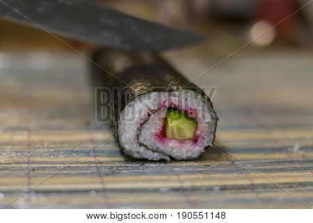Maki Sushi With Cucumber And Caviar Being Cut