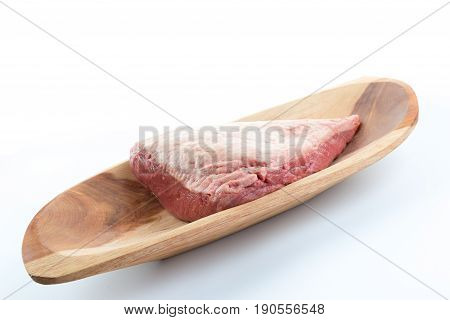 Side View Of A Full Piece Of Raw Cow Beef (picanha) On A Wood Rectangular Bowl Isolated On White Bac
