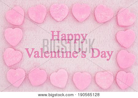 Old fashion Valentine's greeting Retro heart shaped candy on pick fabric with text Happy Valentine's Day