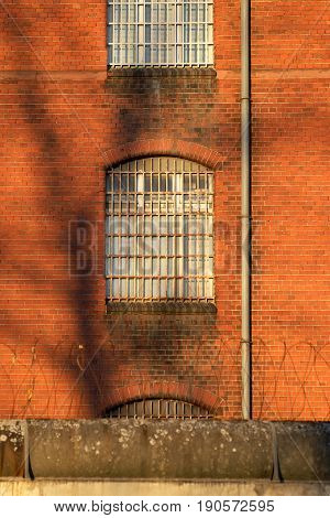 The outside view of an old and abandoned jail in Berlin during sunset