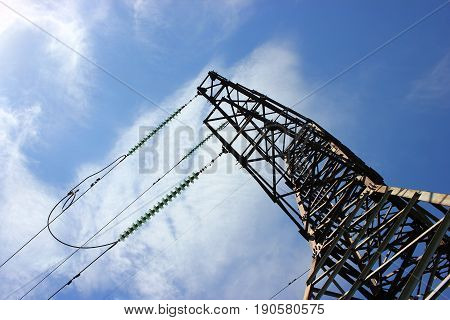 Transmission power tower electricity pylon over blue sky. Steel lattice tower used to support an overhead power line