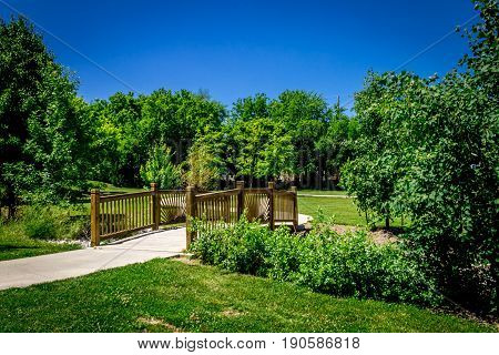Wooden bridge across small creek in the park