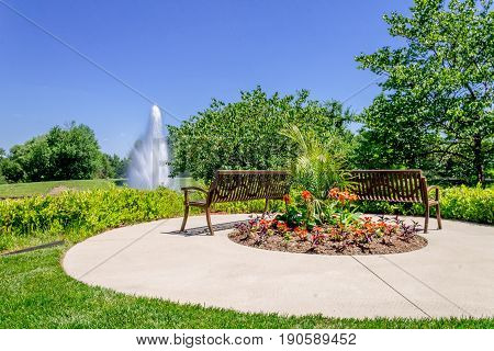 Tranquil rest area in front of a pond with a large fountian
