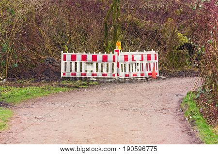 Red and White Street Barricade. Road block or construction site barrier on a road.