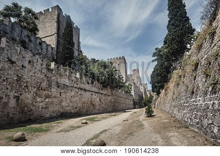 The moat and turrets of the medieval castle of the Joannite Order in the city of Rhodes
