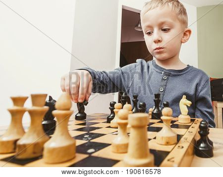 Young Kid Boy Playing Chess Having Fun