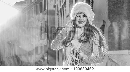 Smiling Woman In Venice, Italy In Winter Using Mobile Phone