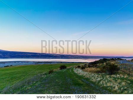 Beautiful sweet colour Pukaki lake in twilight at dusk Mackenzie District Canterbury South Island of New Zealand