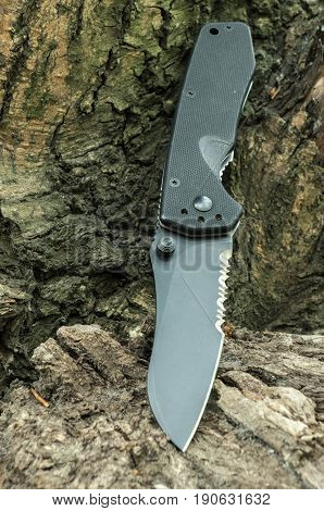 Tactical Knife With A Serritorial Blade.