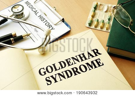 Book with title Goldenhar Syndrome on a table.