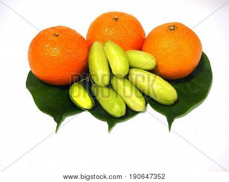 fresh orange fruit on green leaf white background