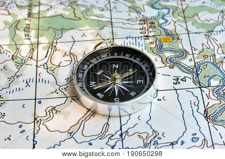 Compass on the map. Navigation tools to avoid getting lost.