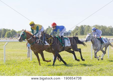 STOCKHOLM SWEDEN - JUNE 06 2017: Tough fight between three jockeys riding gallop arabian race horses at Nationaldags Galoppen at Gardet. June 6 2017 in Stockholm Sweden