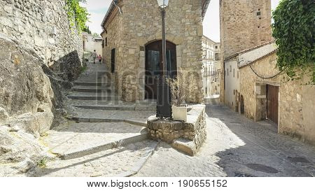 Tourists with dog walking by narrow streets of Trujillo downtown Spain. Extremadura