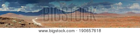 Gravel road at Damaraland with Grootberg mountains in the distance Namibia Africa