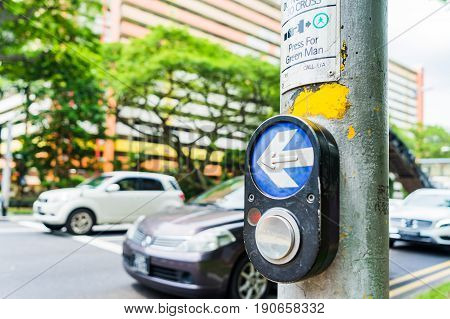 Button for traffic light and Cars in background. Traffic lights at the crossroads. Button of the mechanism lights traffic lights on the street. System control traffic light intersection close.