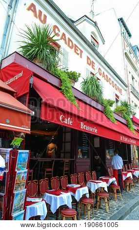 PARIS - JULY 1: View of typical paris cafe on Julne 1, 2017 in Paris. Montmartre area is among most popular destinations in Paris, Au cadet de Gascogne is a typical cafe.