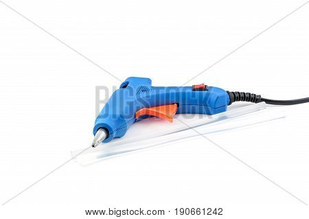 Glue gun with glue rods on a white background.