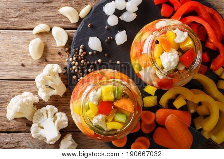 Giardiniera Salad From Pickled Cauliflower, Pepper And Carrots Close-up In Glass Jars. Horizontal To