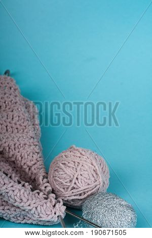 Ball of wool with spokes for handmade knitting on wooden table. Knitting wool and knitting needles