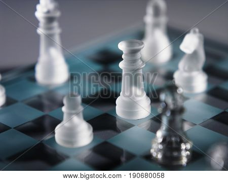 Elevated view part of a chess board with the chess pieces