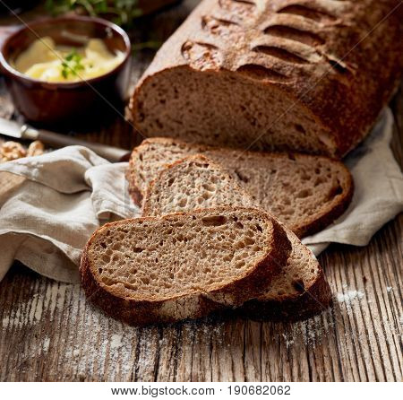Slices of rustic sourdough bread on wooden table