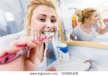 Woman Brushing Cleaning Teeth In Bathroom