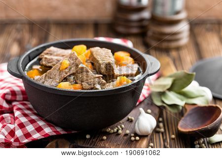 Delicious braised beef meat in broth with vegetables goulash