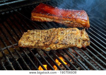 Baby Back Or Pork Spareribs BBQ Roasted On The Hot Flaming Charcoal Grill