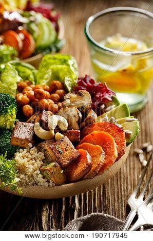 Buddha bowl of mixed vegetables, healthy and nutritious vegan meal on wooden table