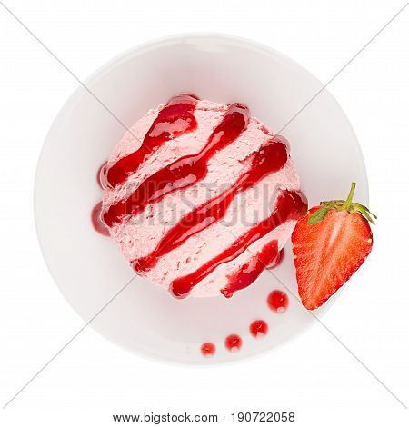 Ice cream pink scoop on plate decorated jam strips and slice strawberry top view isolated on white background.