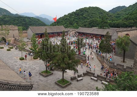 Badaling China - July 26, 2013: tourists getting together to visit Great Wall of China on Badaling territory, view from above