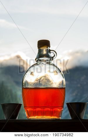 Drinking plum brandy after a long hiking tour in the mountains in Austria during sunset