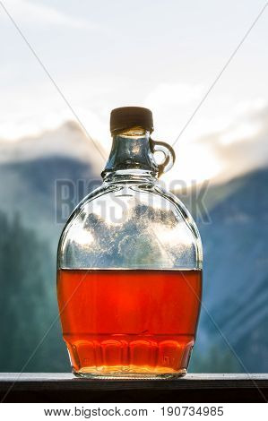 Drinking plum brandy after a long hiking tour in the mountains in Austria during sunset