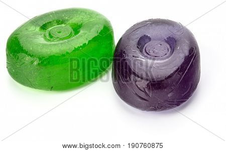 Two colorful fruit hard sugar candies,  boiled sweeties or sugar plums isolated on white background cutout