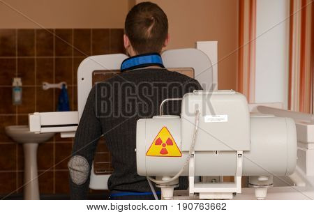 MOGILEV BELARUS - APRIL 24 2015: Young man undergoes annual mandatory fluorographic examination on digital X-ray apparatus 