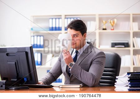 Businessman with mask in office hypocrisy concept