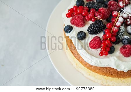 Top View Of Fluffy Japanese Cotton Cheesecake Garnished With Forest Berries On A White Plate On A Wh