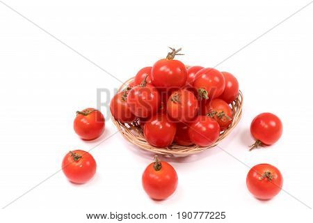 Fresh tomatoes  in a basket on white background.