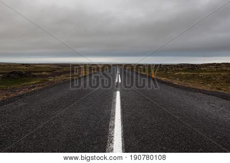 Iceland Road Leading Straight To The Horizon. Empty Straight Road Line In Rural Icelandic Landscape