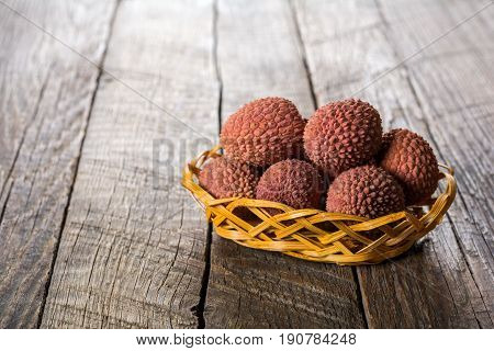 Lychees exotic fruits on a wooden background