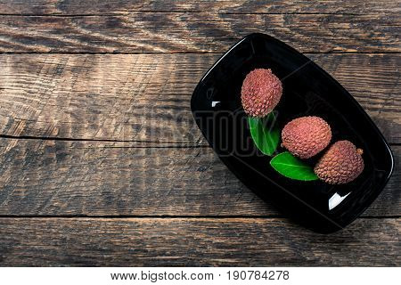 Lychees exotic fruits on a wooden background