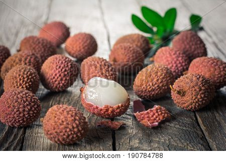 Lychees exotic fruits on a wooden background