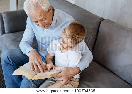 Home tutor. Logical inventive senior gentleman being a tutor while sharing his hobby with his grandchild and hoping he taking it after him
