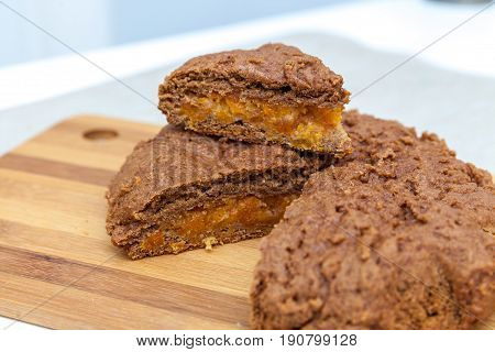Cut apricot pie with slices on a cutting board