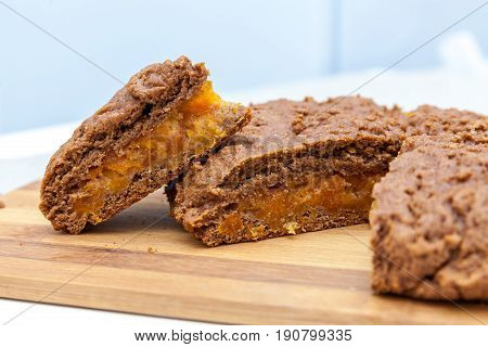 Cut apricot pie with slices on a cutting board